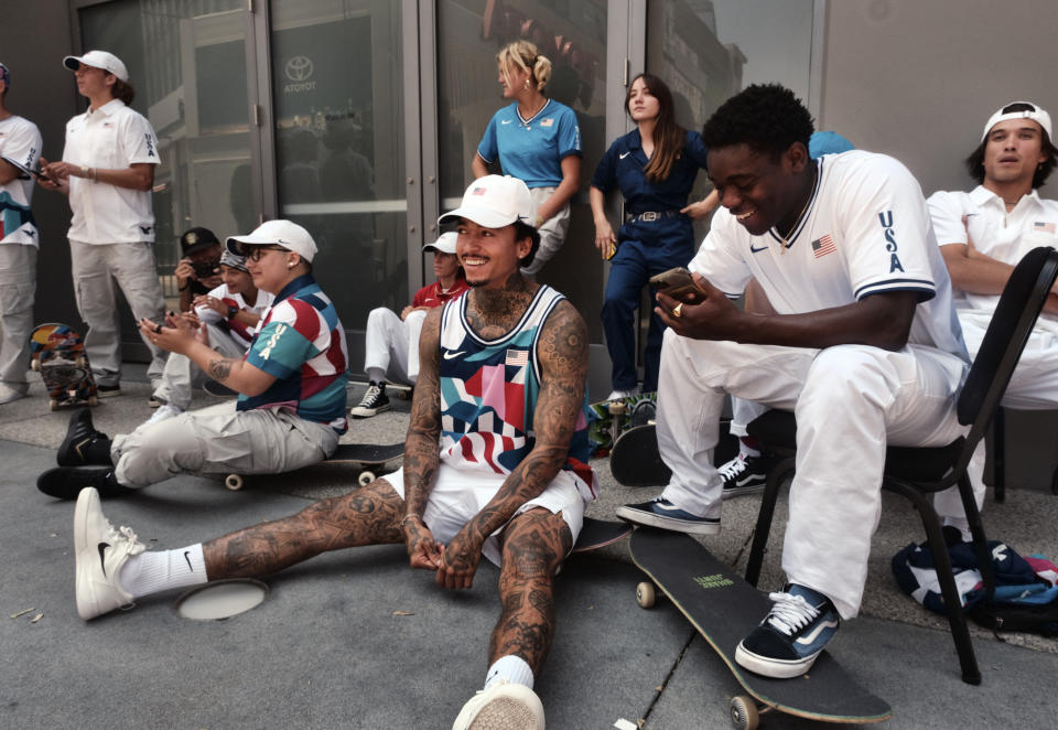 Nyjah Huston, center, waits with the rest of his teammates to be introduced at a news conference in downtown Los Angeles on Monday, June 21, 2021. Huston and the rest of the first U.S. Olympic skateboarding team was introduced in Southern California on Monday where the sport was invented roughly 70 years ago. Skateboarding is an Olympic sport for the first time in Tokyo, and the Americans are expected to be a strong team. (AP Photo/Richard Vogel)