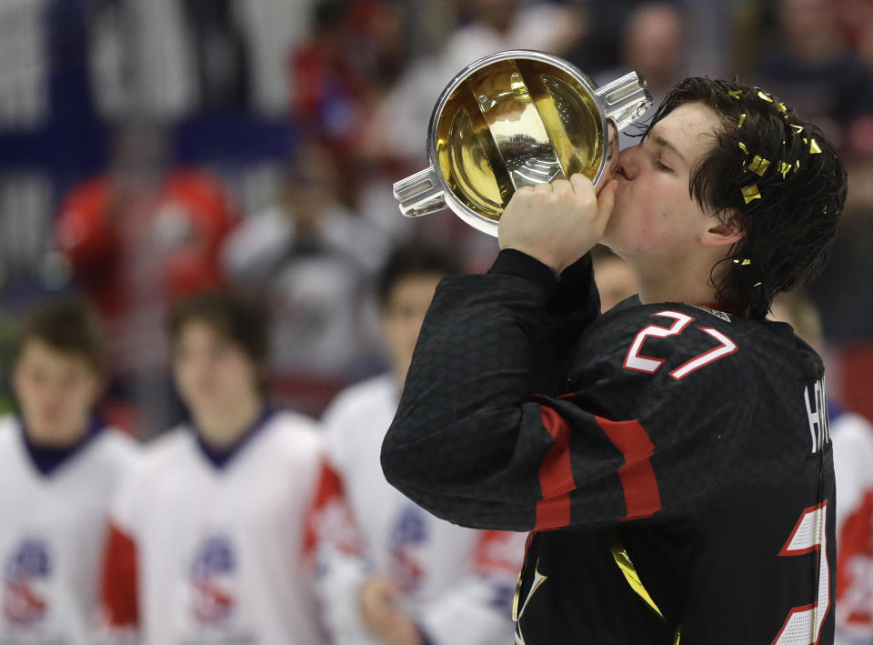 Canada's Barett Hayton kisses the trophy after winning the U20 Ice Hockey Worlds gold medal match between Canada and Russia in Ostrava, Czech Republic, Sunday, Jan. 5, 2020. (AP Photo/Petr David Josek)