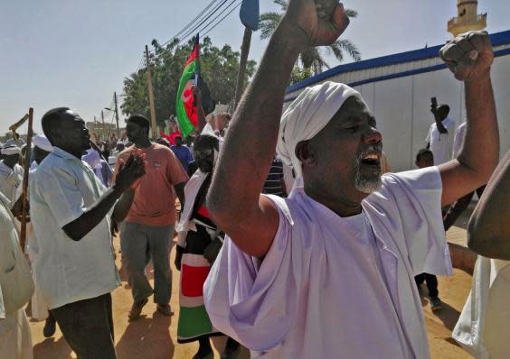 Sudanese men shout slogans during an anti-government protest on 18 January (AFP/Getty Images)