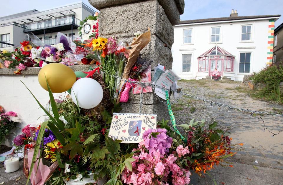 Flowers and tributes are pictured outside the former home of Irish singer Sinead O'Connor, in Bray, eastern Ireland, ahead of her funeral on August 8, 2023. A funeral service for Sinead O'Connor, the outspoken singer who rose to international fame in the 1990s, is to be held on Tuesday in the Irish seaside town of Bray.