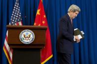 U.S. Secretary of State John Kerry walks off after a news conference in Beijing February 14, 2014. Kerry said on Friday that President Barack Obama has asked for possible new policy options on Syria given the worsening humanitarian situation there. (REUTERS/Evan Vucci/Pool)