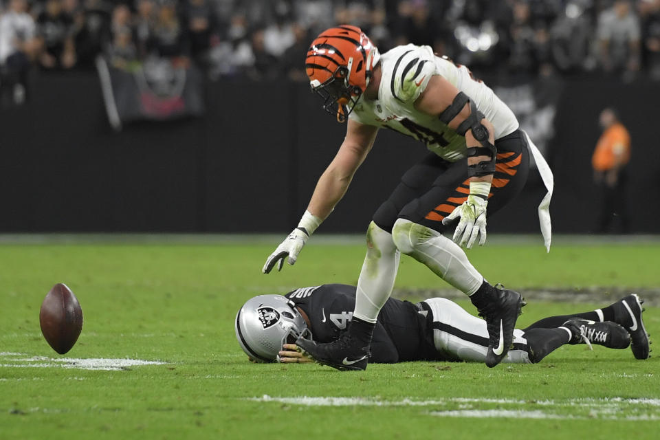 Cincinnati Bengals defensive end Sam Hubbard (94) recovers a fumble by Las Vegas Raiders quarterback Derek Carr (4) during the second half of an NFL football game, Sunday, Nov. 21, 2021, in Las Vegas. (AP Photo/David Becker)