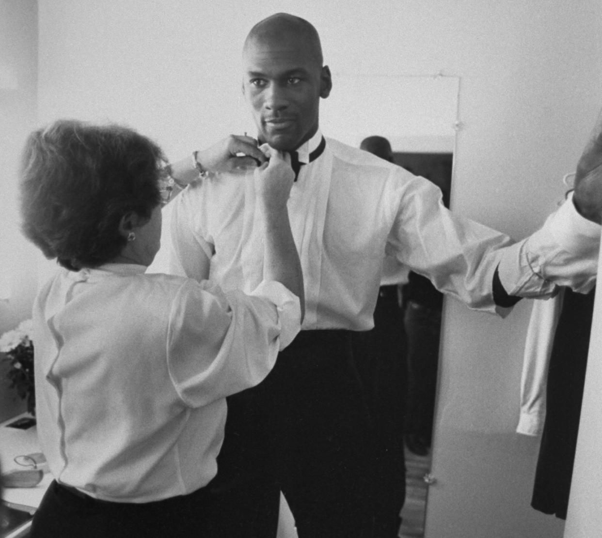 Michael Jordan, modeling a line of formal wear, is fitted for a tuxedo with the help of stylist Jane Collins. (Photo by Steve Kagan/The LIFE Images Collection via Getty Images/Getty Images)