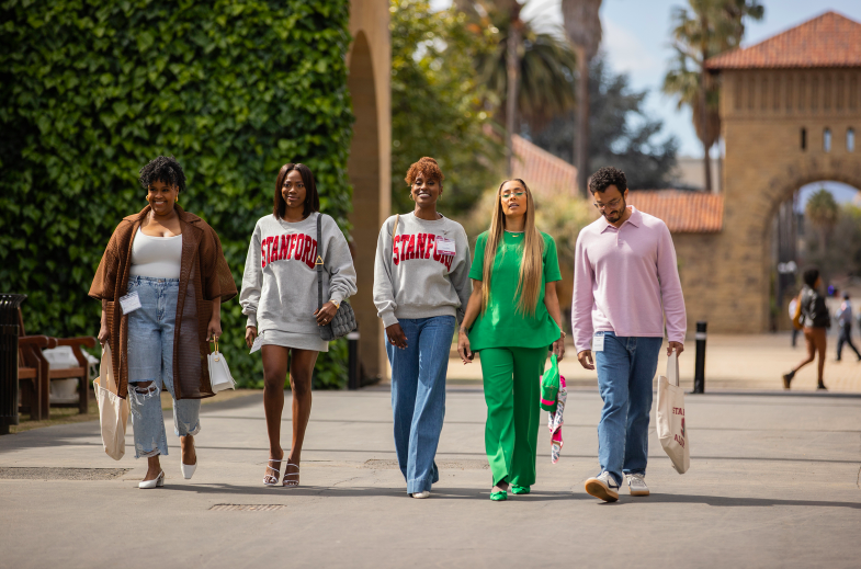 Still of "Insecure" Season 5, Episode 1, from left to right stand Natasha Rothwell, Yvonne, Issa, Amanda, and Wade Allain-Marcus, who are walking around Stanford