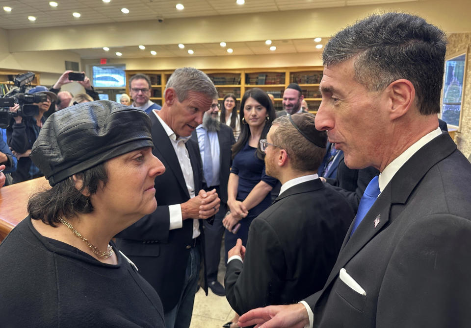 Tennessee Gov. Bill Lee, back left, and Rep. David Kustoff, R-Tenn., right, speak with people at Margolin Hebrew Academy-Feinstone Yeshiva of the South on Monday, Oct. 30, 2023, in Memphis, Tenn. Lee and Kustoff are praising security measures at the school where an ex-student with a gun was stopped from entering the building in July. (AP Photo/Adrian Sainz)