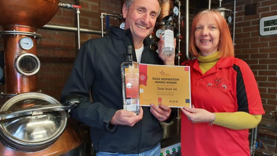 Eastern Daily Press: Patrick and Sarah Saunders of Black Shuck Gin with their Inspiration Award certificate.