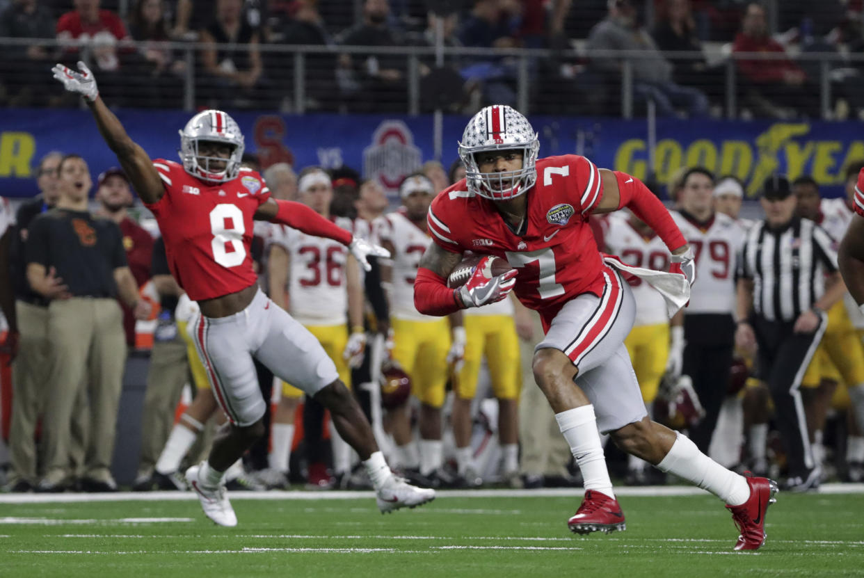 Ohio State safety Damon Webb (7) runs an interception in for a touchdown in front of cornerback Kendall Sheffield (8) during the first half of the Cotton Bowl NCAA college football game against Southern California in Arlington, Texas, Friday, Dec. 29, 2017. (AP Photo/LM Otero)