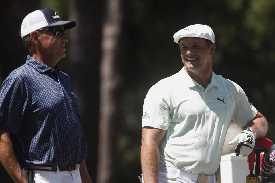Davis Love III, left, and Bryson DeChambeau, talk on the 11th tee, during the first round of the RBC Heritage golf tournament, Thursday, June 18, 2020, in Hilton Head Island, S.C. (AP Photo/Gerry Broome)