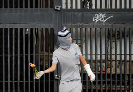 An opposition supporter throws a molotov cocktail during clashes with security forces at a rally against Venezuela's President Nicolas Maduro in Caracas, Venezuela, April 26, 2017. REUTERS/Carlos Garcia Rawlins