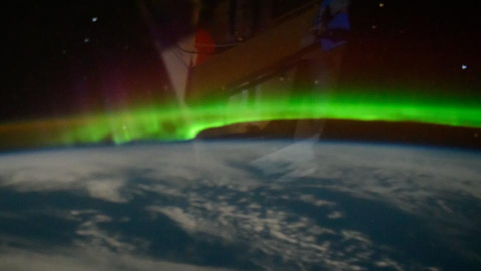 a ribbon-like aurora above the Earth