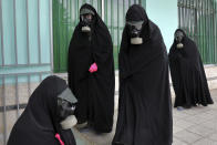 Cleric women wearing protective clothing and "chador," a head-to-toe garment, arrive a cemetery to prepare the body of a victim who died from the new coronavirus for a funeral, in the city of Ghaemshahr, in north of Iran, Thursday, April 30, 2020. (AP Photo/Ebrahim Noroozi)