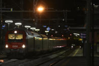 A train stoped by authorities stands on the tracks at the train statin on the Italian side of the Brenner Pass, Italy, Sunday, Feb. 23, 2020. Austria halted all train traffic to and from Italy following fears that a train on Sunday night had two people on board who may have been infected with the COVID-19 virus. (AP Photo/Matthias Schrader)