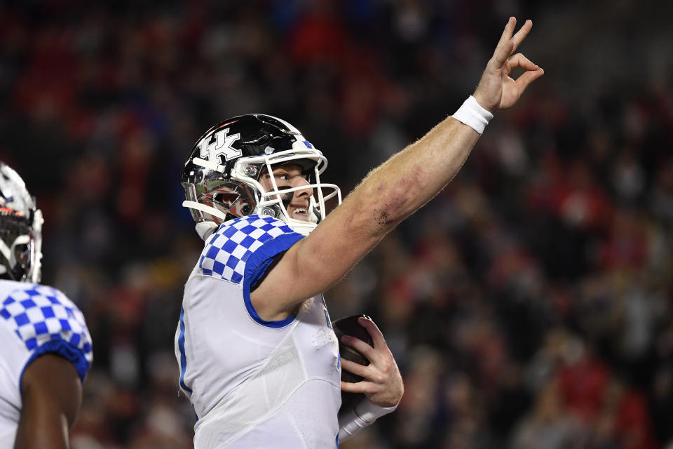 Kentucky quarterback Will Levis (7) holds up three fingers to the crowd after scoring his third rushing touchdown during the first half of an NCAA college football game against Louisville in Louisville, Ky., Saturday, Nov. 27, 2021. (AP Photo/Timothy D. Easley)