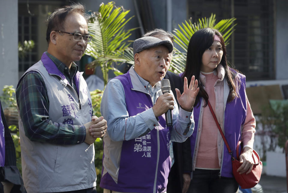 Chui Pak-tai, center, a Taiwanese of Hong Kong descent, answers to the media in front of his campaign headquarters in New Taipei City, Taiwan, on Dec. 8, 2023. At 72, Chui, a former Hong Kong pro-democracy district councilor who secured Taiwan residency 11 years ago, is running for legislative office. Although he faces long odds, his campaign draws attention to the immigration challenges of the Hong Kong diaspora.(AP Photo/Chiang Ying-ying)