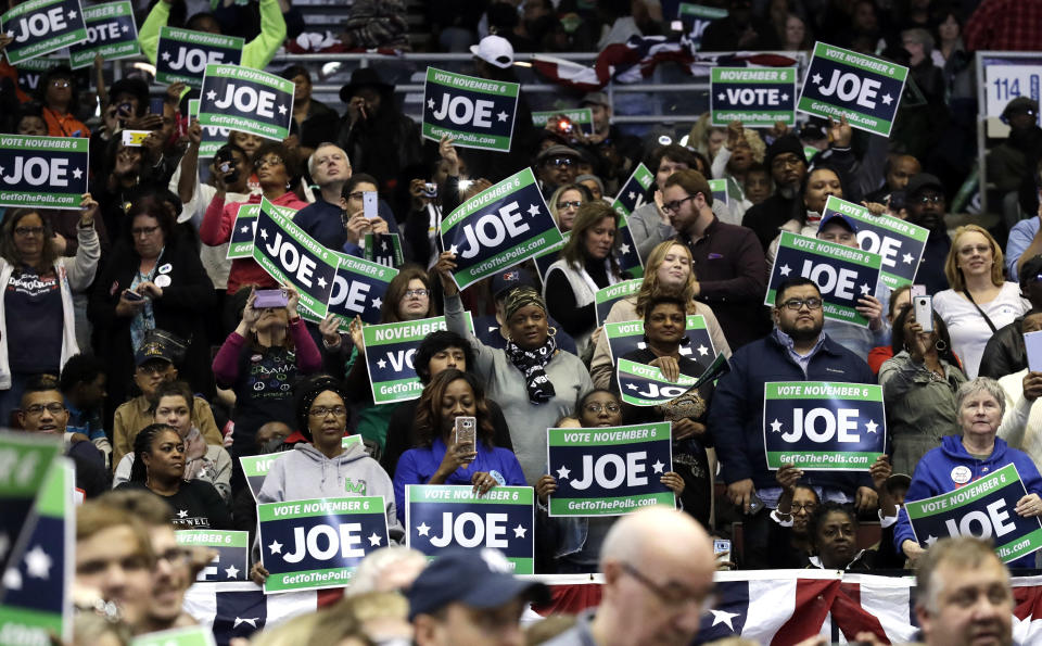 CORRECTS TO SAY THAT DONNELLY IS A CONGRESSIONAL CANDIDATE, NOT A GUBERNATORIAL CANDIDATE - Supporters hold signs during a rally to support Indiana Democratic congressional candidate U.S. Sen. Joe Donnelly at Genesis Convention Center in Gary, Ind., Sunday, Nov. 4, 2018. (AP Photo/Nam Y. Huh)