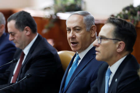 Israeli Prime Minister Benjamin Netanyahu (C) sits next to Cabinet Secretary Tzachi Braverman (R) and Israeli Intelligence and Transportation Minister Israel Katz (L) at the start of the weekly cabinet meeting at the Prime Minister's office in Jerusalem February 11, 2018. REUTERS/Ronen Zvulun