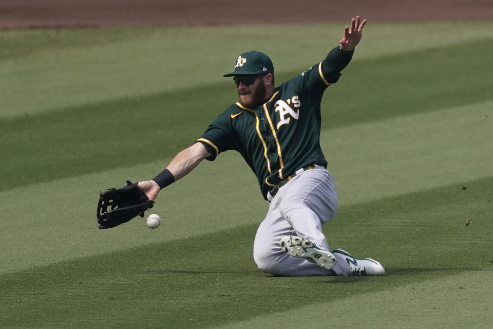 Oakland Athletics left fielder Robbie Grossman cannot catch a base hit by Houston Astros' Josh Reddick during the fourth inning of Game 4 of a baseball American League Division Series in Los Angeles, Thursday, Oct. 8, 2020. (AP Photo/Ashley Landis)