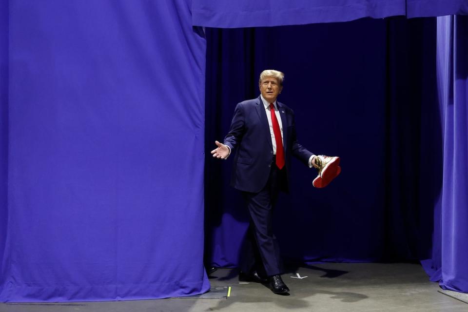 The real Mr Trump holding his new ‘super limited’ sneakers (Getty Images)