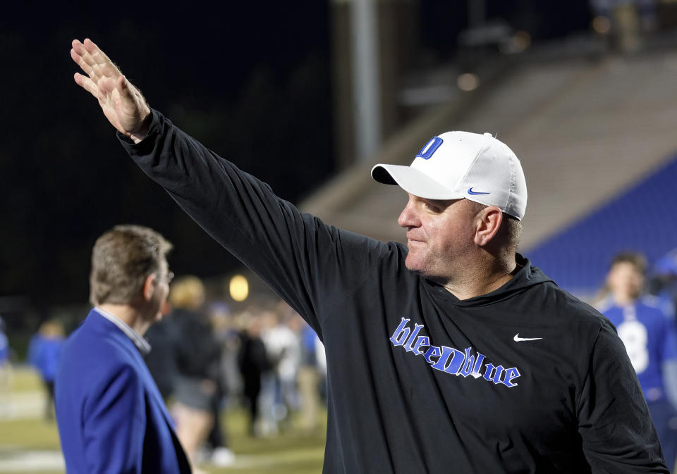 Duke head coach Mike Elko waves to fans as he walks off the field after earning a victory in Duke's final regular season NCAA college football game against Wake Forest in Durham, N.C., Saturday, Nov. 26, 2022. (AP Photo/Ben McKeown)