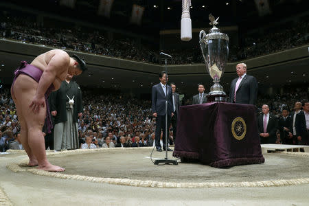 U.S. President Donald Trump prepares to present the President’s Cup to wrestler Asanoyama, the winner of the Summer Grand Sumo Tournament at Ryogoku Kokigikan Sumo Hall in Tokyo, Japan May 26, 2019. REUTERS/Jonathan Ernst