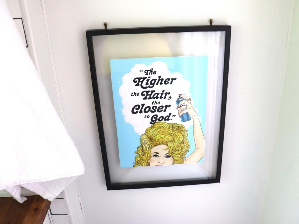 A Dolly Parton sign reading "The higher the hair, the closer to God."