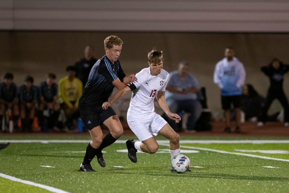 Pueblo Centennial's Shon West, right, works the ball past Pueblo West's Aiden VanManen during a matchup on Tuesday, October 3, 2023.