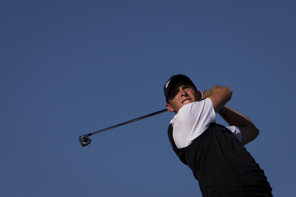 FILE - In this Sunday, Oct. 9, 2011 file photo, Lorenzo Gagli from Italy hits his drive from the 16th tee during the fourth round of the Madrid Masters Golf tournament at Alcala de Henares near Madrid, Spain. Italian golfers Lorenzo Gagli and Edoardo Molinari have withdrawn from the Oman Open on the European Tour amid reports they are being isolated to determine if they have the virus spreading in Europe, Wednesday, Feb. 26, 2020. Gagli tells an Italian newspaper he is isolated in a hotel room at the Oman Open while the European Tour awaits results from a test after he reported having a fever last week. (AP Photo/Arturo Rodriguez, File)