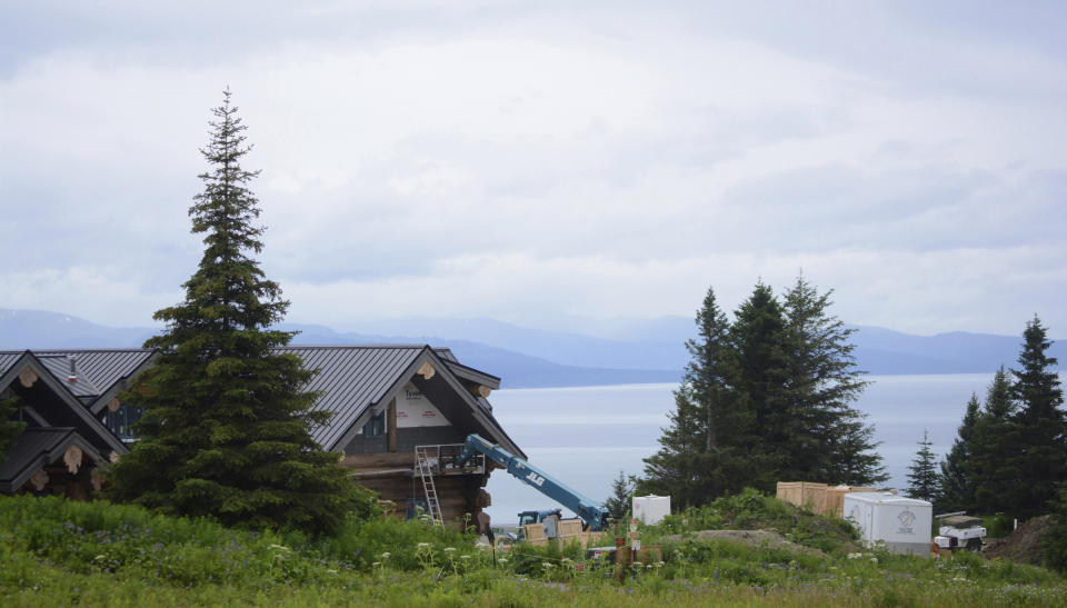 This July 9, 2019 photo shows part of country musician Zac Brown's log home, visible from Dorothy Drive overlooking Kachemak Bay in Homer, Alaska. Brown has lost a bid to limit public access to his property. Brown had asked the Kenai Peninsula Borough Planning Commission to remove easements allowing the access along his property in hills above Homer, a small city on Kachemak Bay on Alaska's Kenai Peninsula, KSRM-AM reported Tuesday, Aug. 13, 2019. The commission voted 5-4 against Brown's request Monday following more than two hours of public testimony. (Michael Armstrong/Homer News via AP)