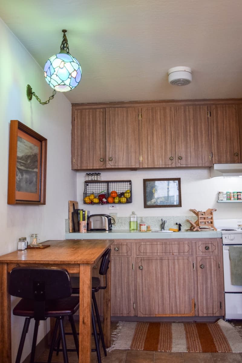 Kitchen with wooden panel cabinets and small breakfast table.