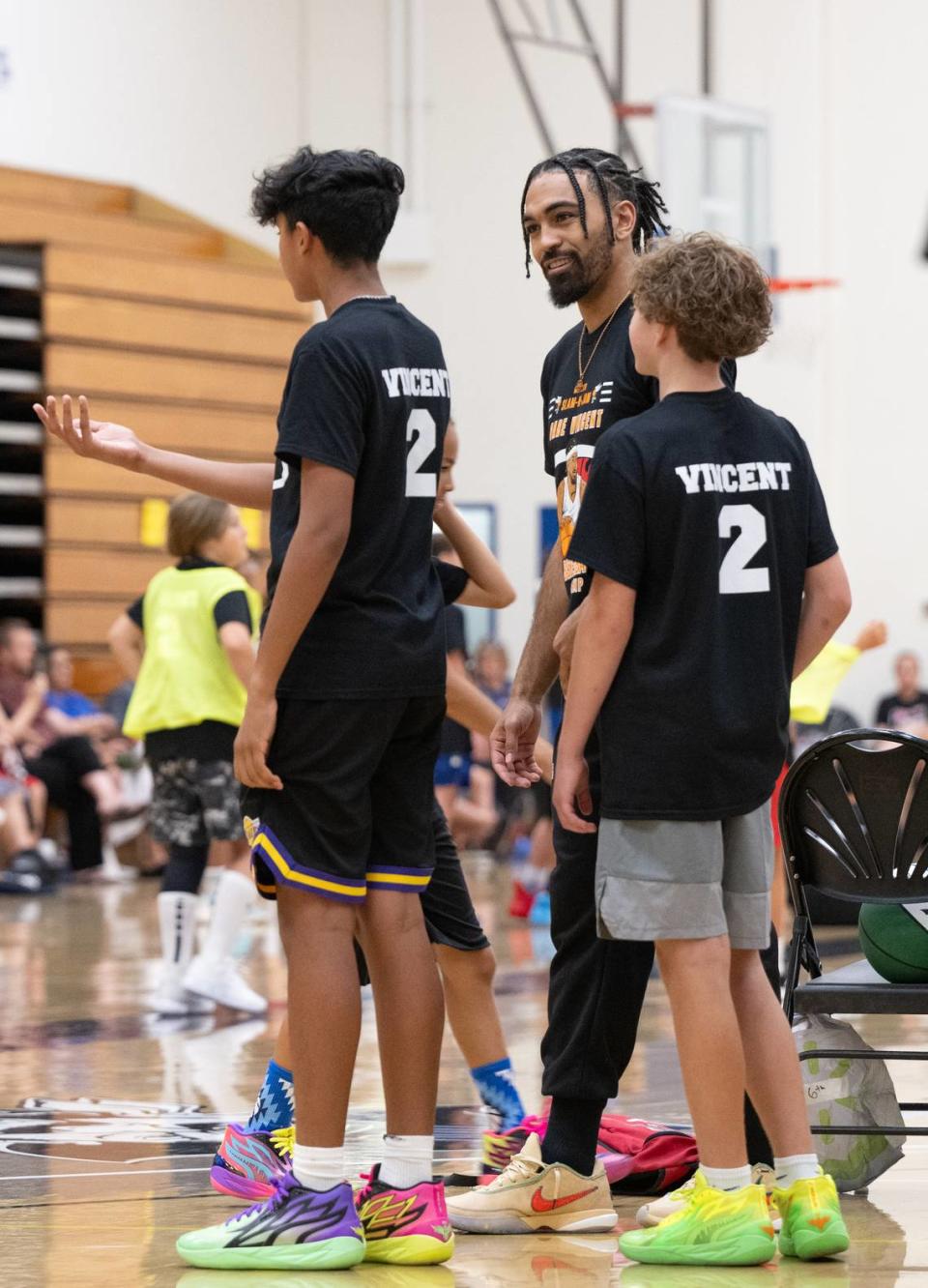 NBA player Gabe Vincent talks with kids during the Modesto Slam-N-Jam Youth Basketball Camp at Modesto Junior College in Modesto, Calif., Friday, July 7, 2023.