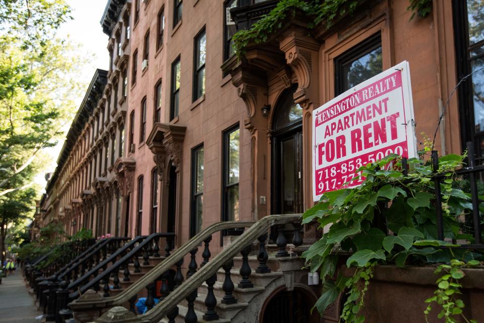 A sign advertises an apartment for rent along a row of brownstone townhouses in the Fort Greene neighborhood on June 24, 2016 in the Brooklyn borough of New York City.