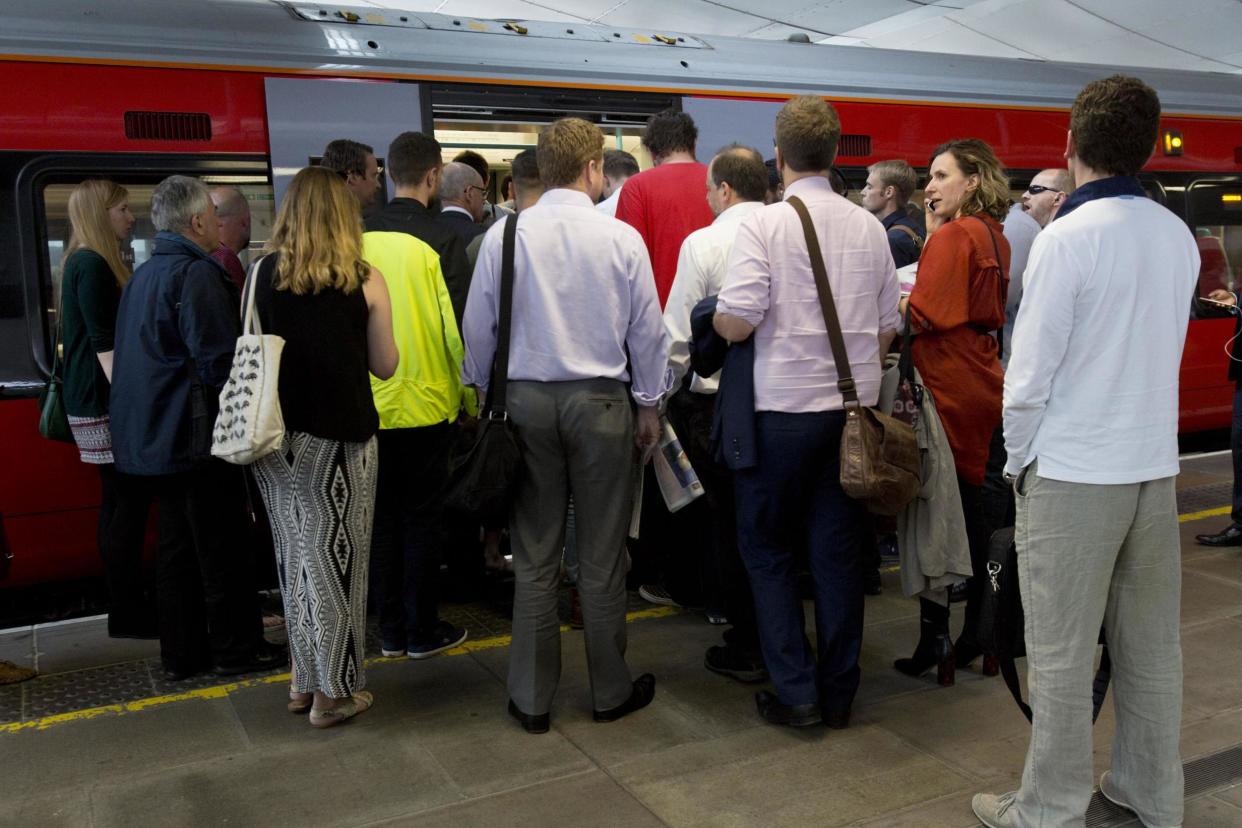 Commuters cram into a packed train as Chris Grayling calls for first class carriages to be cut: PA