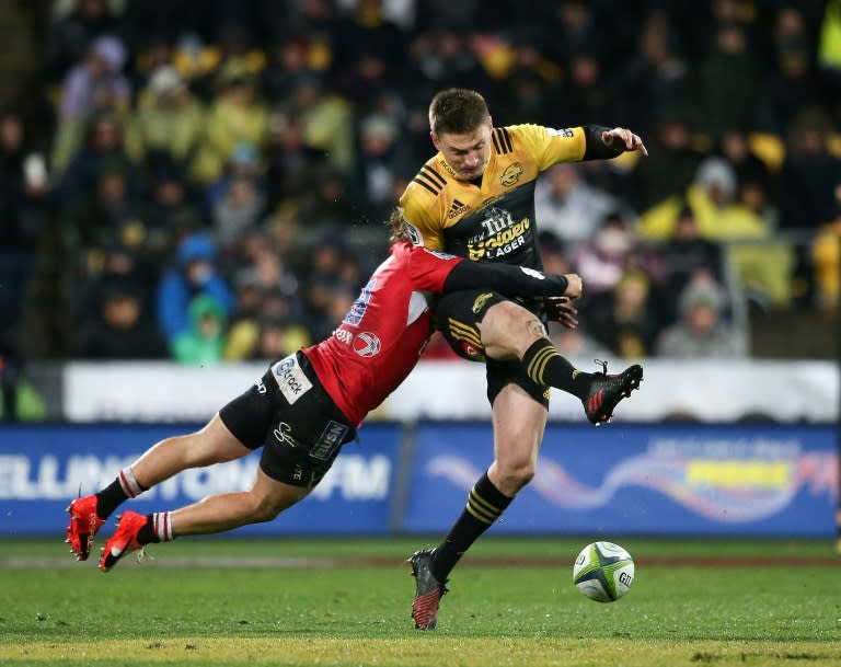 Beauden Barrett of the Wellington Hurricanes (R) is tackled by Faf de Klerk of the Lions of South Africa during their Super Rugby match, at Westpac Stadium in Wellington, in August 2016