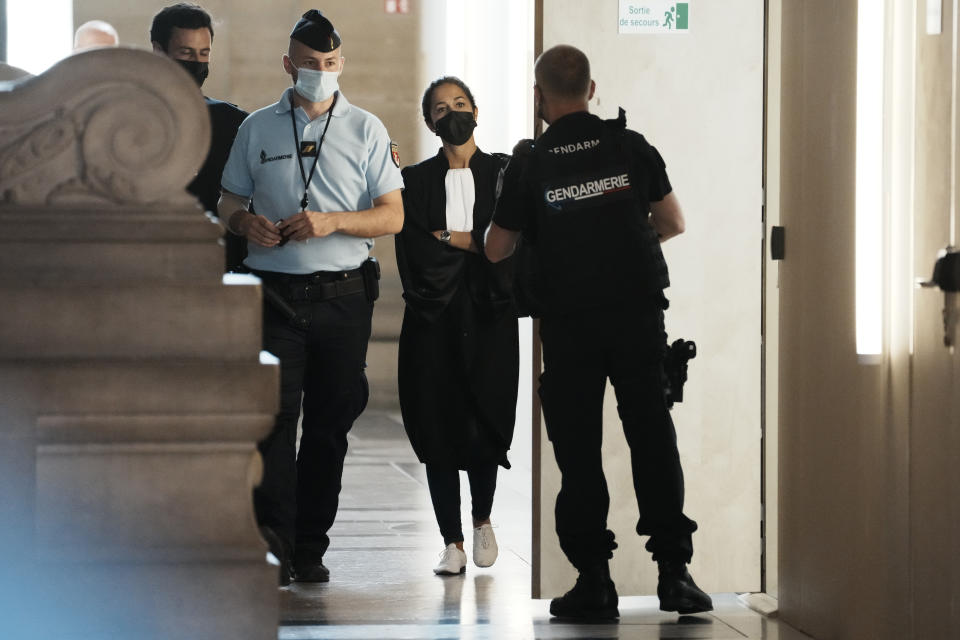 Salah Abdeslam's lawyer Olivia Ronen, center, arrives at the courtroom Wednesday, Sept. 8, 2021 in Paris. France is putting on trial 20 men accused in the Islamic State group's 2015 attacks on Paris that left 130 people dead and hundreds injured. The proceedings begin Wednesday in an enormous custom-designed chamber. Most of the defendants face the maximum sentence of life in prison if convicted of complicity in the attacks. Only Abdeslam is charged with murder. (AP Photo/Thibault Camus)