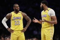 Los Angeles Lakers' LeBron James (23) talks to Anthony Davis (3) during the first half of an NBA basketball game against the Brooklyn Nets Thursday, Jan. 23, 2020, in New York. (AP Photo/Frank Franklin II)