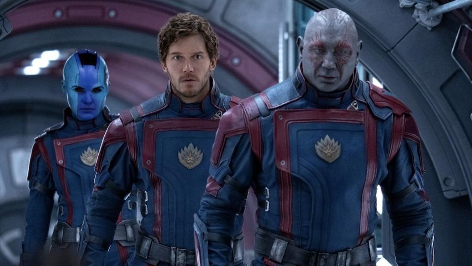 Drax, Quill, and Nebula in matching suits walk through their ship in Guardians of the Galaxy Vol. 3