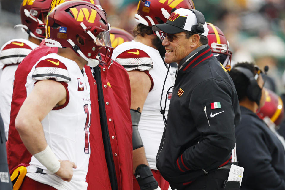 EAST RUTHERFORD, NEW JERSEY - DECEMBER 24: Head Coach Ron Rivera of the Washington Commanders talks to Sam Howell #14 of the Washington Commanders during the first half at MetLife Stadium on December 24, 2023 in East Rutherford, New Jersey. (Photo by Rich Schultz/Getty Images)