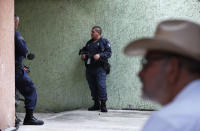 In this Oct. 3, 2019 photo, Hipolito Mora, founder of the state's civilian armed self-defense movement, speaks during an interview at his home in Ruana, Michoacan state, Mexico, with the continued presence of armed men to keep him safe. (AP Photo/Marco Ugarte)