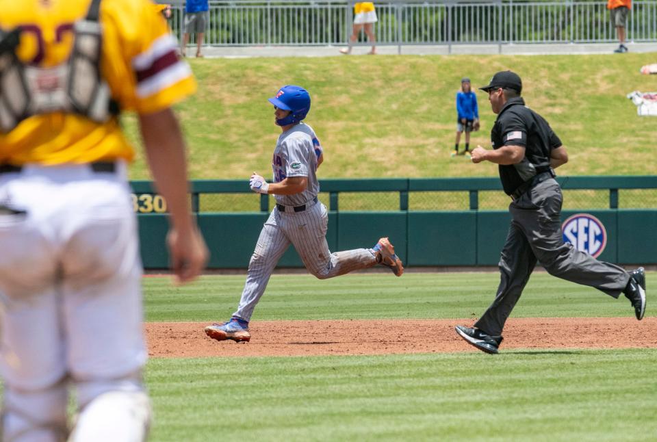 Florida's Wyatt Langford, back left, runs on a home run against Central Michigan in the top of the third inning during an NCAA college baseball tournament regional game Sunday, June 5, 2022, in Gainesville, Fla.