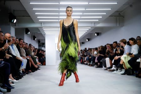 Models present creations during the Mark Fast catwalk show at London Fashion Week in London