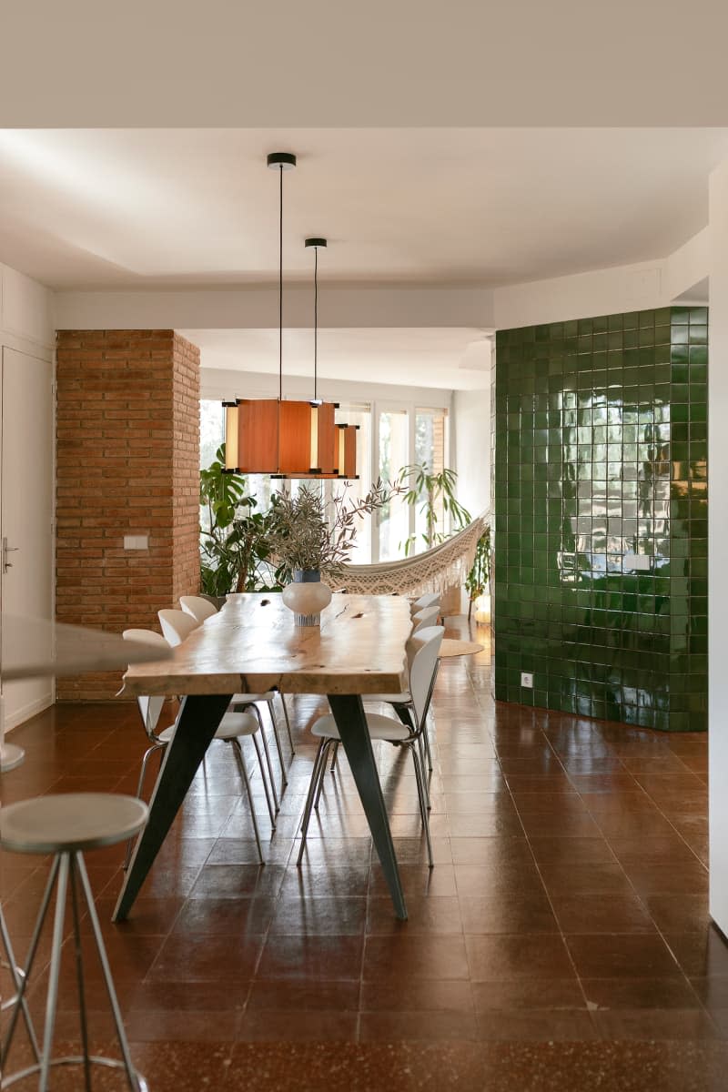 Green tiled wall in dining room.