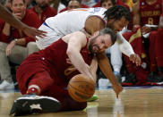 New York Knicks guard Jalen Brunson, top, and Cleveland Cavaliers forward Kevin Love fight for the ball during the second half of an NBA basketball game, Sunday, Dec. 4, 2022, in New York. The Knicks won 92-81. (AP Photo/John Munson)