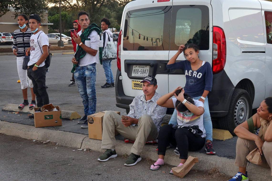 Venezuelan migrants who recently crossed the southern U.S. border with Mexico sit near San Antonio’s shelter, waiting for offers of work or buses out of town.