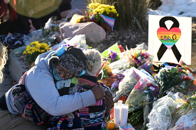 People at a makeshift memorial near Club Q