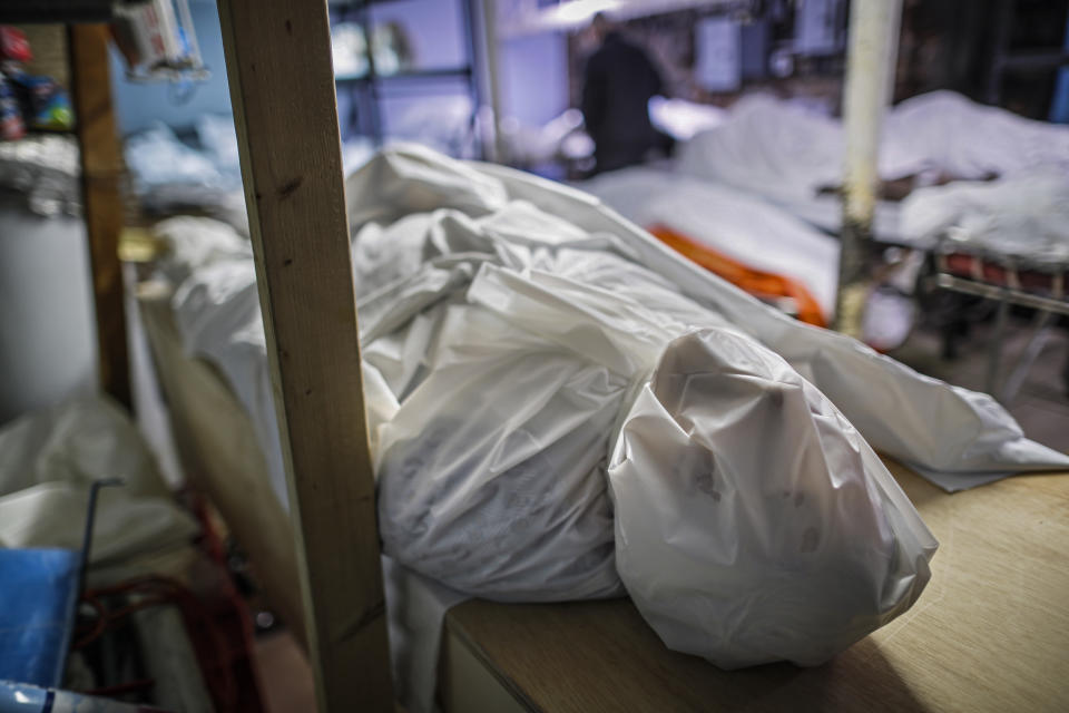 Bodies are wrapped in protective plastic in a holding facility during the coronavirus pandemic at Daniel J. Schaefer Funeral Home, April 2, 2020, in the Brooklyn borough of New York. (AP Photo/John Minchillo)