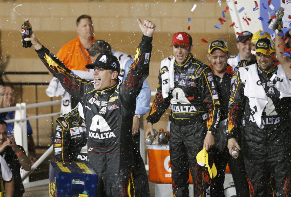 NASCAR driver Jeff Gordon celebrates in victory lane after winning the Sprint Cup Series auto race at Kansas Speedway in Kansas City, Kan., Saturday, May 10, 2014. (AP Photo/Orlin Wagner)