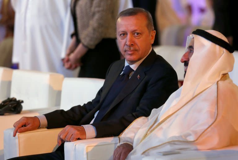 Turkish Prime Minister Recep Tayyip Erdogan (L) attends the opening session of a forum in the Emirati city of Sharjah on February 24, 2013. Erdogan said that his country will "not remain silent" over Syrian President Bashar al-Assad's "crimes" against his own people