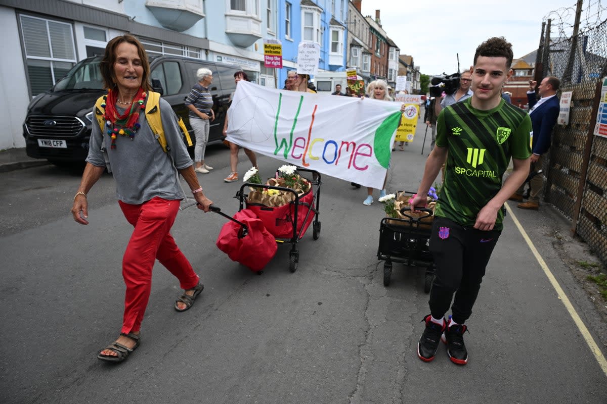 Protesters delivered ‘welcome packs’ as the first 15 migrants arrived at the barge on Monday – just four days before being evacuated (Getty)