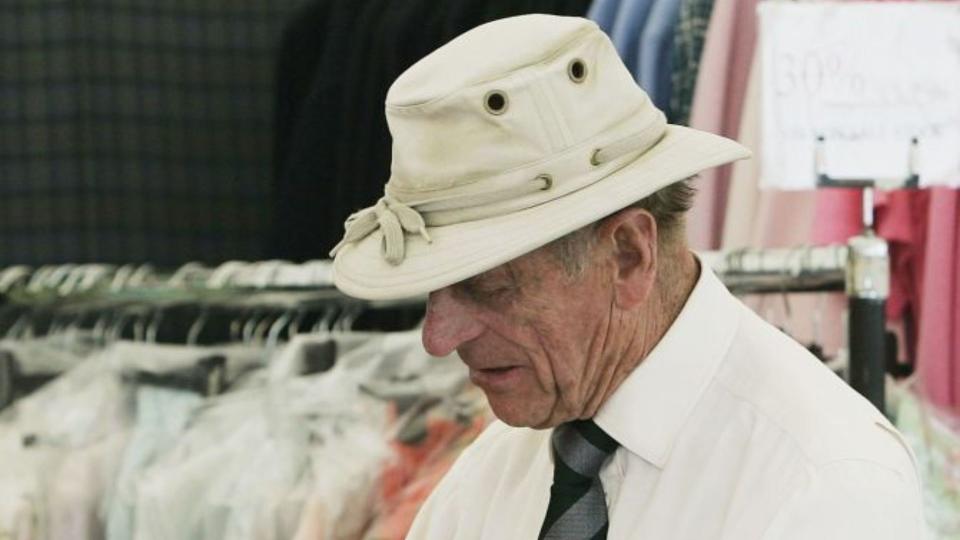 Prince Philip, Duke of Edinburgh tries on a pair of sheepskin gloves in one of the show stalls on the second day of the Royal Windsor Horse Show on May 12, 2006 in Windsor, England