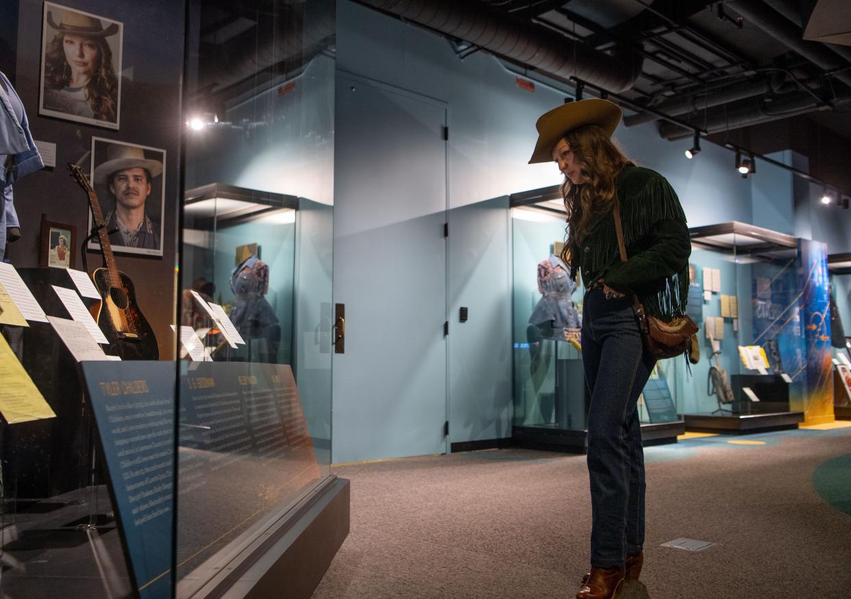 Kelsey Waldon looks at her name and artifacts behind the display glass in the American Currents Gallery at the Country Music Hall of Fame in Nashville, Tenn., Tuesday, Feb. 27, 2024.